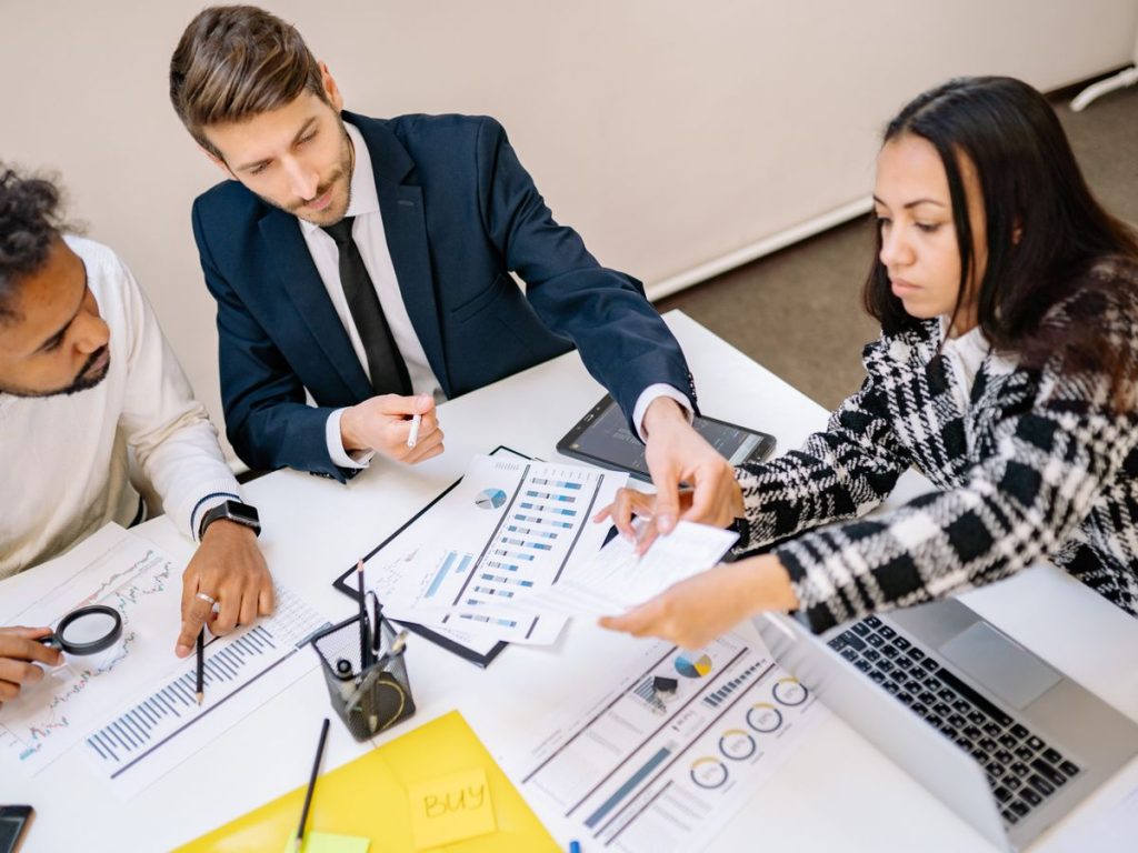 Business professionals engaging in a collaborative meeting with charts and documents