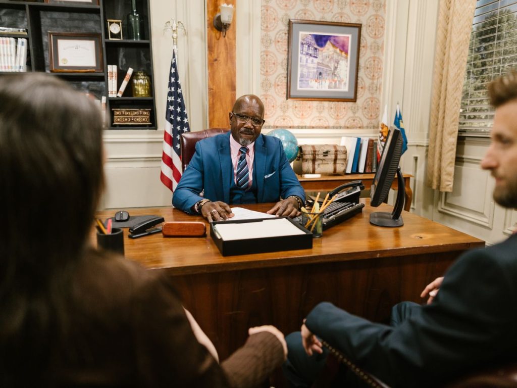 A professional lawyer meeting with clients in his office at a legal consultation