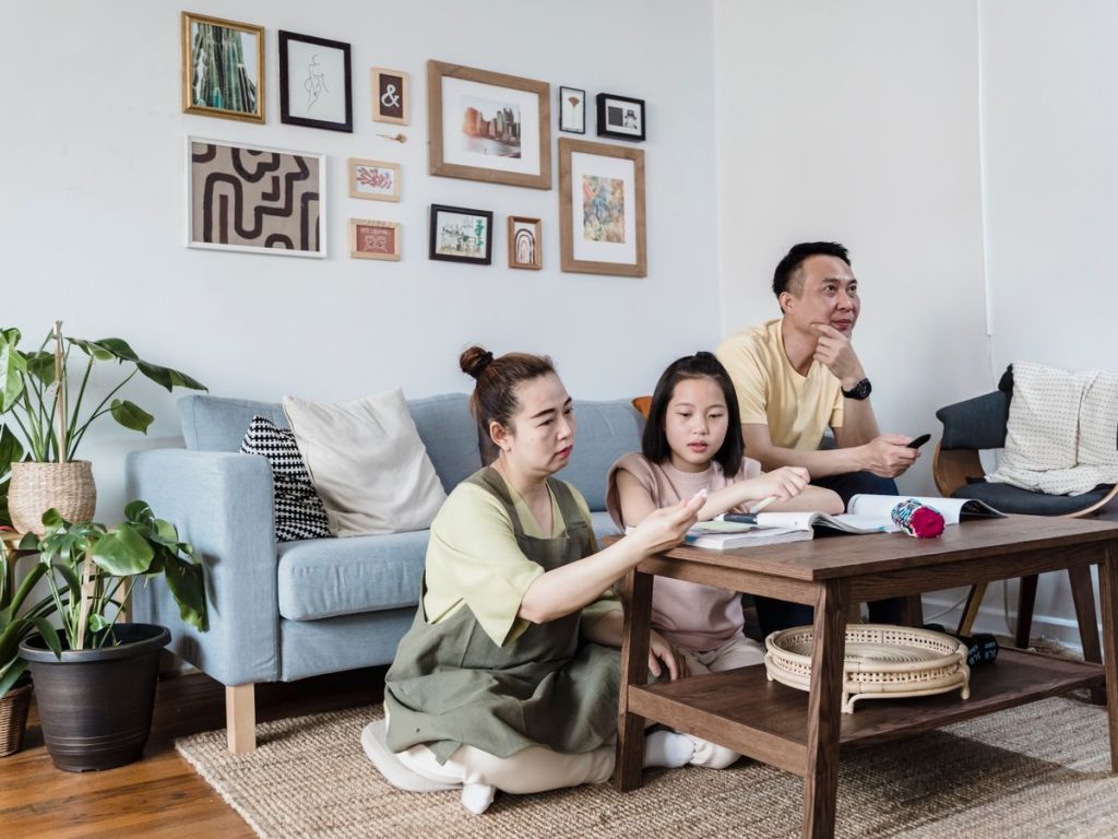 A family enjoying quality time at home in a cozy and stylish living room setting