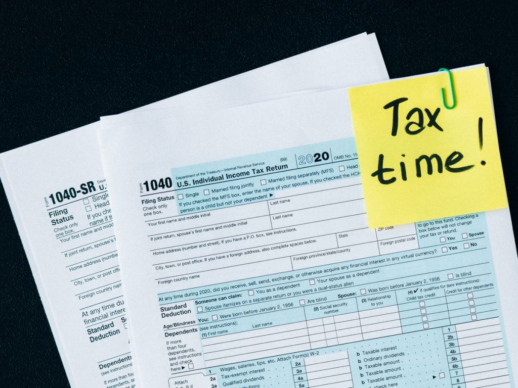 U.S. tax documents with a 'Tax time!' reminder, highlighting the importance of filing deadlines