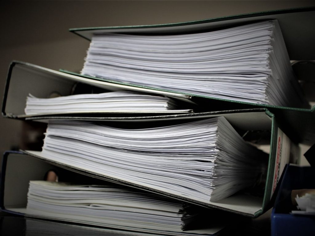 Close-up of stacked binders filled with documents for office or educational use