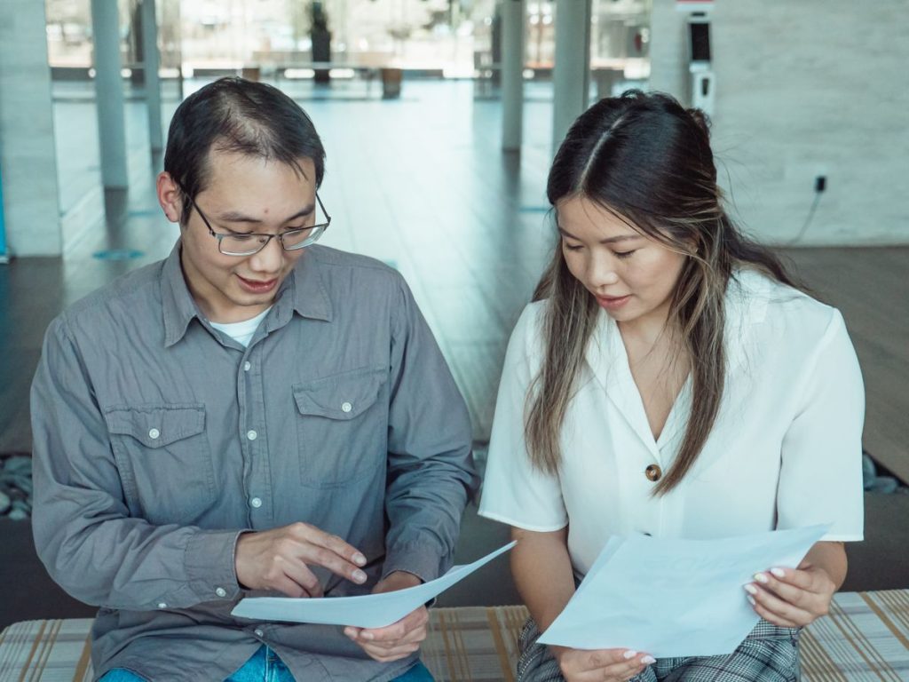 Couple reviewing documents together at a table
