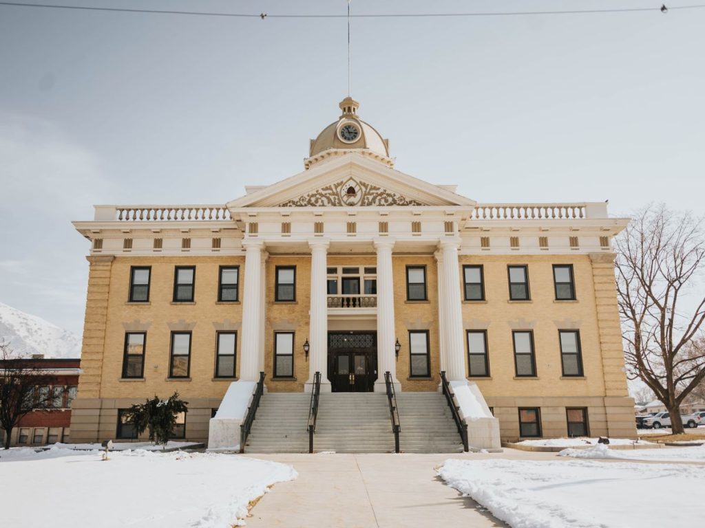 Historic county courthouse with a clock tower on a winter day