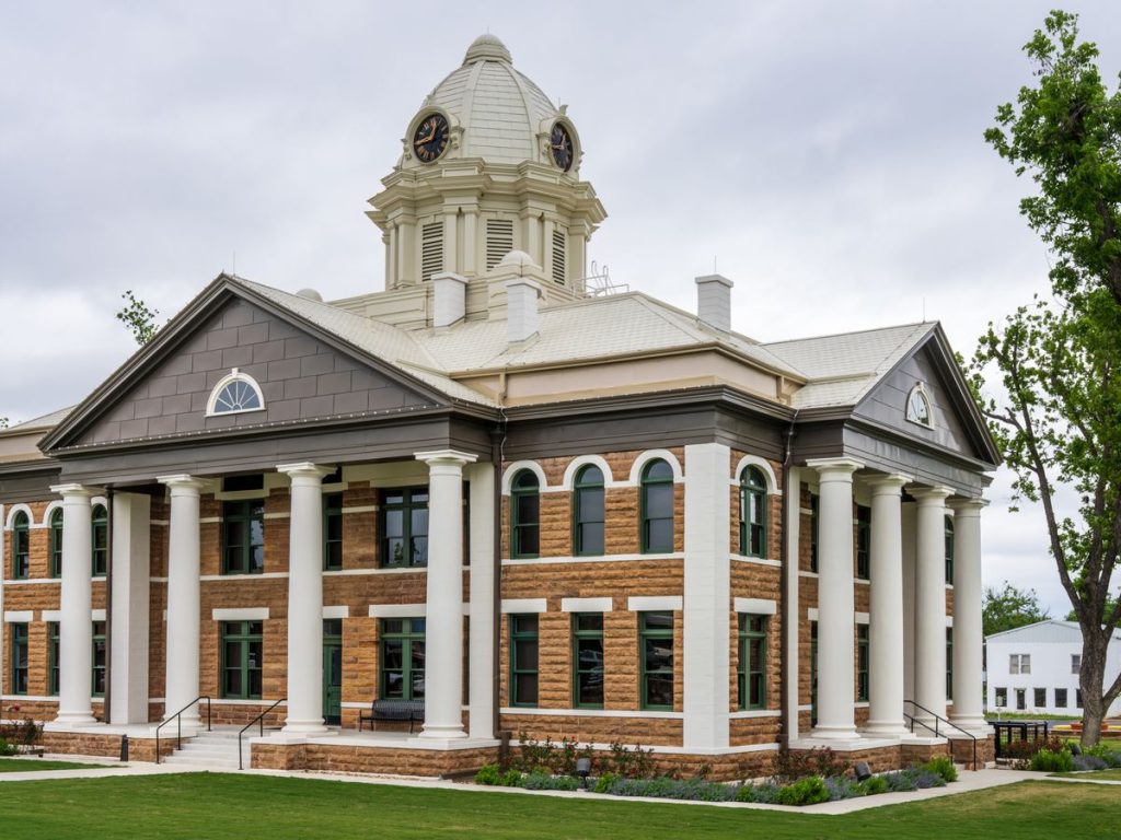 Historic county courthouse with a domed clock tower against a cloudy sky
