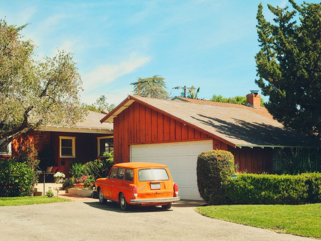 Single-story California home with a classic car in the driveway