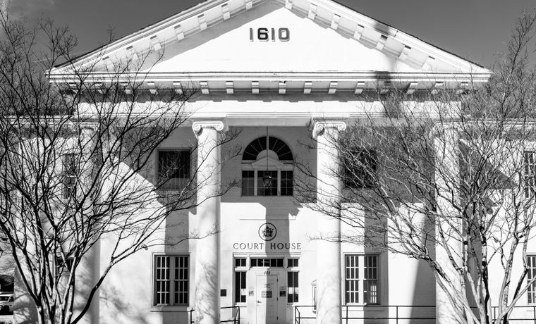 A black and white view of the historic courthouse facade in Hampton, Virginia, showcasing classic architecture